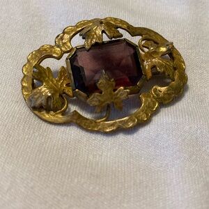 Grandmother’s Vintage broach. Goldtone with amethyst colored center.
